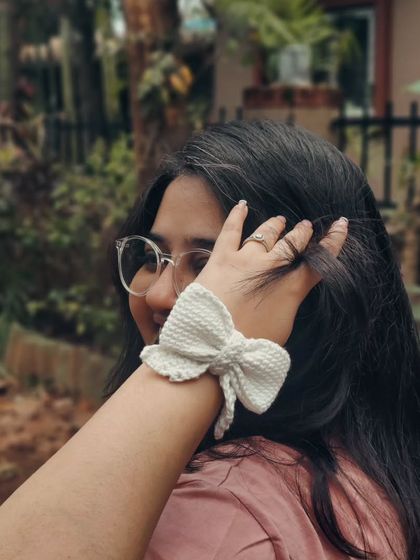 When in doubt, put a bow on it. This photo shows my crochet bow hair tie worn as a bracelet, showcasing its versatility and soft texture.