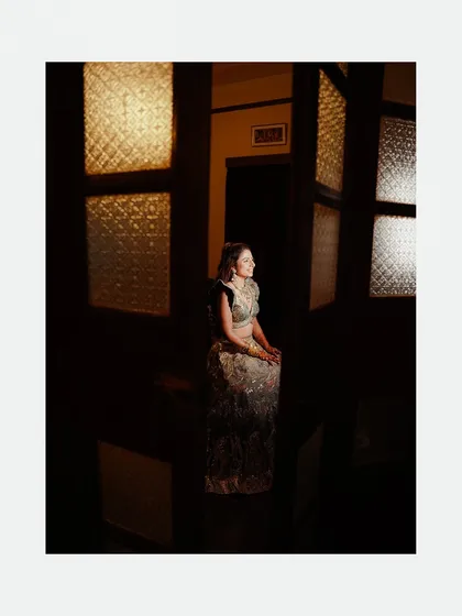 This portrait is all about using architectural elements and light. We'll show you how to see and use patterns, like the light filtering through these textured glass panes, to create a visually interesting and artistic composition that feels both quiet and powerful.