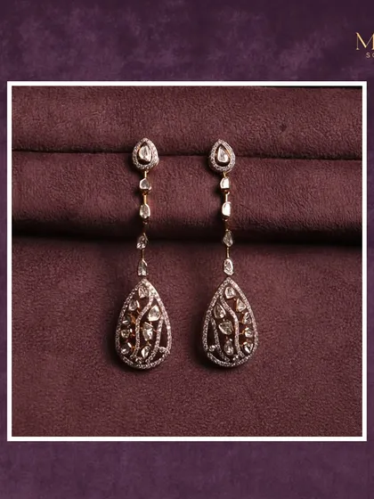 These long, dangling Polki earrings are perfect for the festive season. The intricate design and teardrop shape add a touch of traditional elegance to your look.