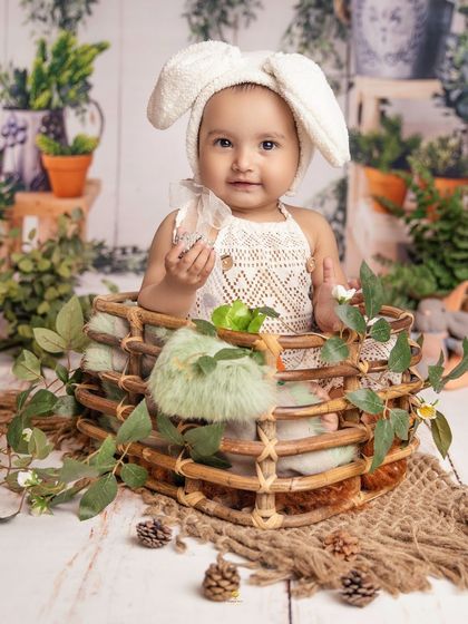 My cutest little bunny baby, surrounded by lush greenery. The soft textures and natural elements in this setup create a gentle and dreamy portrait for this one-year-old.