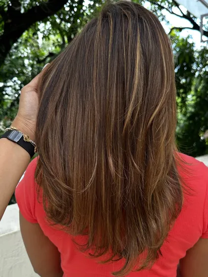 Be the life of every party with hair that shines. I gave her these bold, chunky highlights on a layered cut for a fun and glamorous look that’s sure to turn heads.