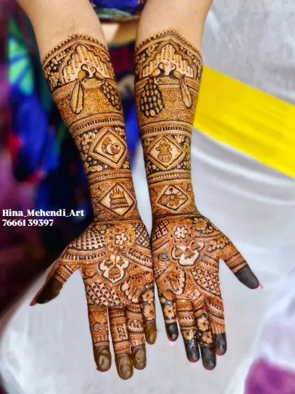 A full view of the auspicious bridal mehendi, combining temple, peacock, and fish motifs for a design full of blessings.
