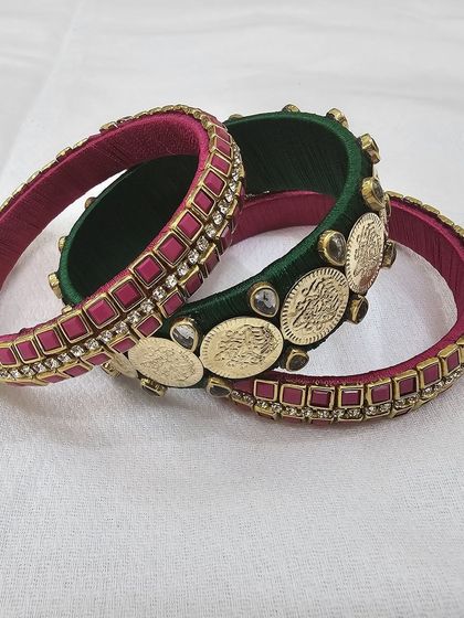 Different angles showcasing the craftsmanship of the green and ruby silk thread bridal bangle set with antique coin details.