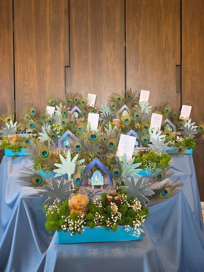 Celebrating a new arrival with a touch of tradition. This large-scale display of 'Little Kanha' themed hampers, adorned with peacock feathers and divine details, was created to share the joy with family and friends.