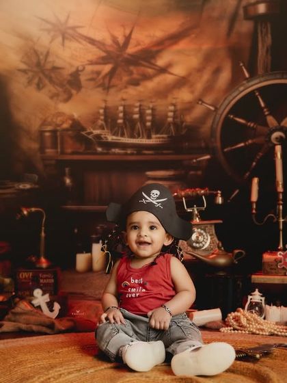The happiest little pirate in the seven seas. This toddler's joyful expression is the real treasure in this fun and adventurous studio setup.