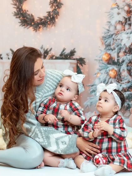 A cozy Christmas portrait of a mother with her twin daughters. We love capturing the unique bond between twins during our holiday mini sessions.