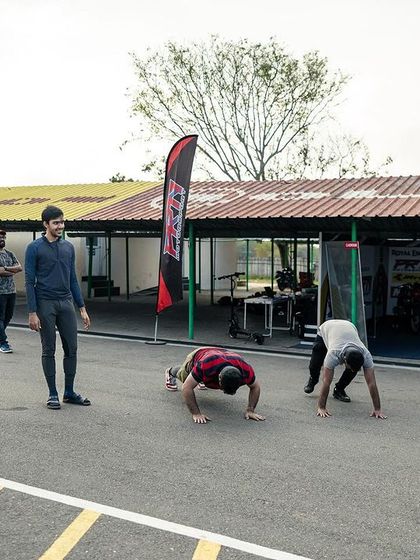 Participants doing push-ups on the track as part of their warm-up. We make fitness engaging and relevant to the demands of motorsport.