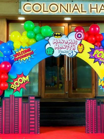 Welcome, heroes. This comic-book-style entrance arch features life-sized Batman and Spiderman figures, a red carpet, and city skyline cutouts to transport guests into the world of superheroes.