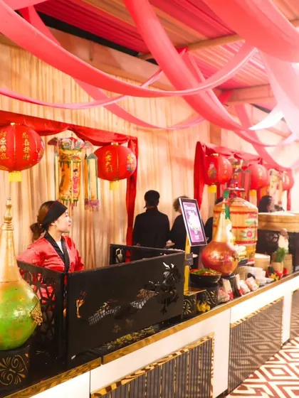 Another view of our Chinese-themed station, set against a backdrop of red drapery. We excel in curating memorable royal moments for any special occasion.