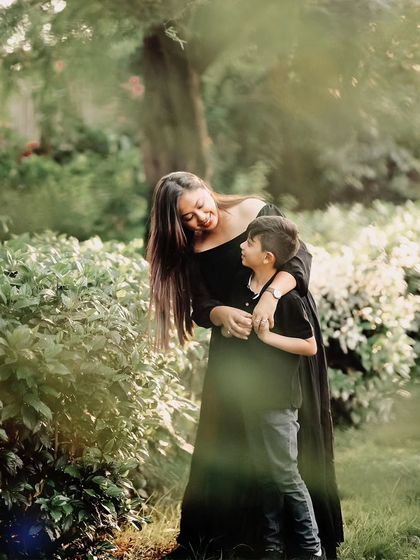A mother and son share a loving gaze amidst the greenery. These individual parent-child shots are a special part of our comprehensive family photoshoots.