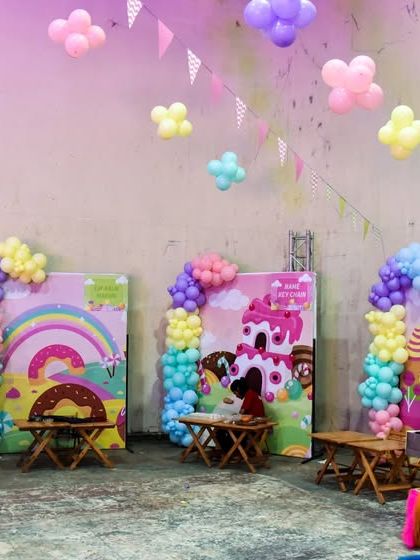 A row of activity stations set against colorful Candyland backdrops.