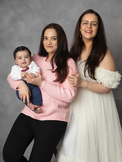 Sisters and the new baby. This portrait captures the special bond between a mother, her sister, and the new addition to their family.