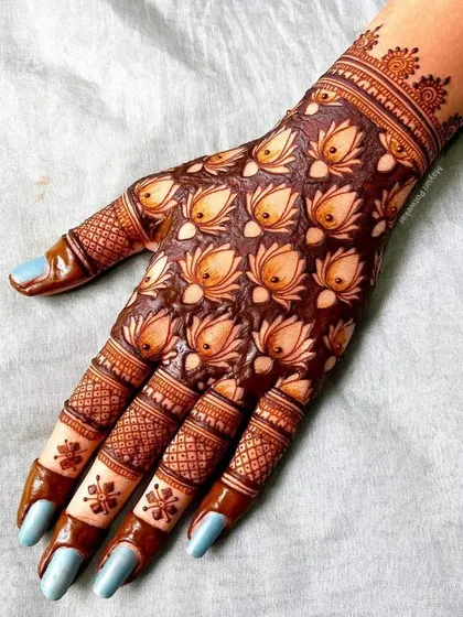 A unique design covering the back of the hand with repeating lotus bud motifs, creating a beautiful and textured pattern.