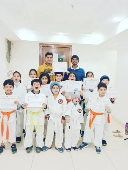A group of our young students proudly holding their new certificates. Their excited faces show how much they value their progress.