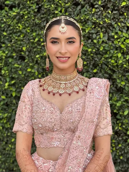 Aarushi was a vision in her pastel pink lehenga for her day wedding. We kept the makeup fresh and radiant, with a clean winged liner and a soft pink lip. These portraits capture the look from every beautiful angle.
