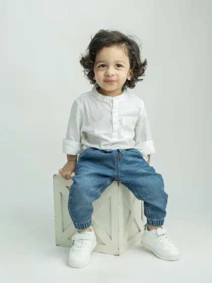 A classic portrait of the little boy, sitting confidently for his photo.