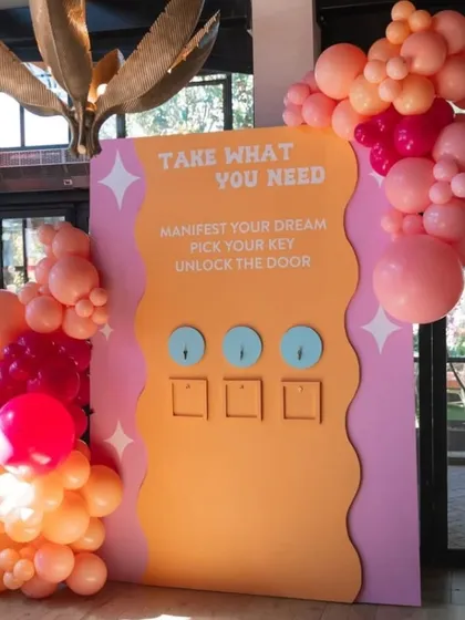 Another creative brand activation idea, where guests can 'Manifest Your Dream' by picking a key to unlock a door, creating an engaging and memorable brand experience.