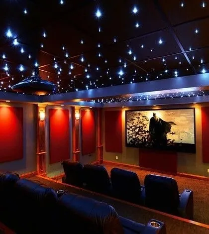 A modern home theater featuring our signature starlight ceiling, creating a magical ambiance for movie nights. The design incorporates clean lines, integrated wall lighting, and premium acoustic panels to ensure both stunning visuals and flawless sound.