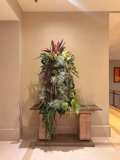 Where nature meets luxury. This grand floral masterpiece uses a base of lush greenery to elevate the ambiance, with unique leaf shapes and textures creating a sophisticated, nature-inspired look.