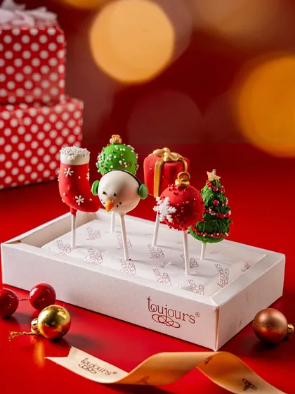 A box of festive cake pops, decorated as snowmen, Christmas trees, and ornaments. These bite-sized treats are fun, easy to share, and a guaranteed hit at any holiday party.