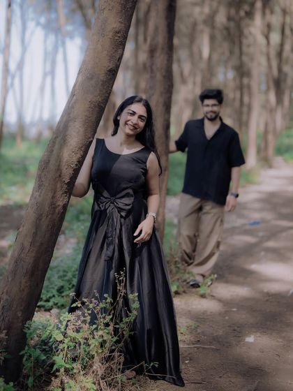 A lovely, candid shot of the bride-to-be, with her partner in the soft-focused background. This style of portrait adds depth and a storytelling element to the photo.