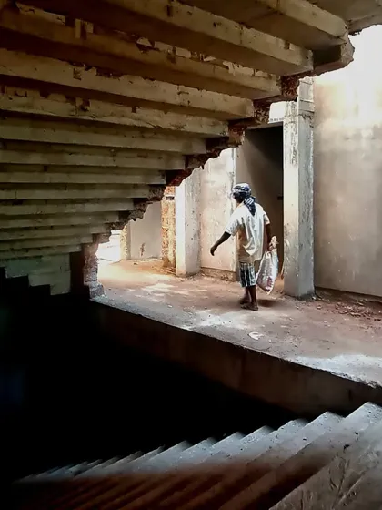 A raw, under-construction view of a staircase at the Brick House, revealing the structural bones that underpin the final, polished form.