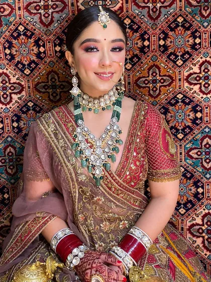 A classic Indian bridal look that is truly timeless. I focused on creating a bright, flawless base with bold eyes and traditional jewellery placement, including the nath and maang tikka. Her happy smile shows how confident and beautiful she felt.
