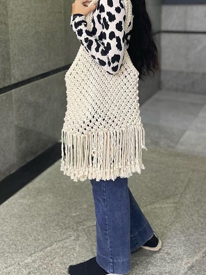 A side view of the macrame tote bag. The open-knot design makes it lightweight, but the cotton thread is very strong, so you can carry a lot in it.