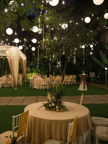 A collection of stunning wedding setups at The Farmhouse Collective. You can see the venue's versatility, from elegant morning ceremonies with floral mandaps to glamorous evening receptions with fairy lights and chic decor. This space is a blank canvas for your dream outdoor wedding in Bengaluru.