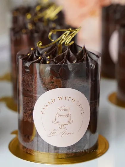 My bite-sized delights are perfect for any celebration. These mini cakes feature layers of tender chocolate sponge enveloped in a rich 54% Belgian dark chocolate ganache, personalized with a topper.