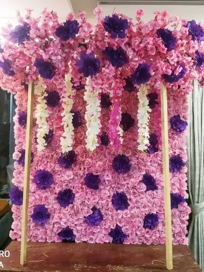 This is a ready-made floral panel featuring a pink and purple polka-dot pattern made from artificial flowers. It's a fun and colorful option for a quick and easy backdrop.