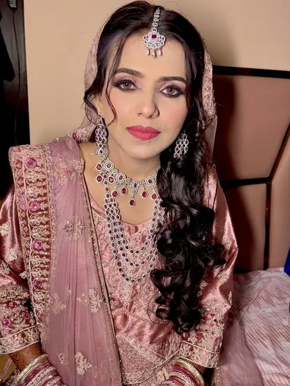 A gorgeous Walima look with dramatic smokey eyes and a soft pink lip. The diamond jewelry adds a touch of modern elegance to the ensemble.