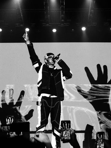 A black and white shot I captured of Talwiinder on stage. Beyond drone work, I also handle event photography to capture powerful still moments like this.