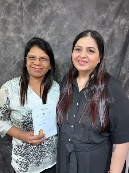 Presenting a certificate to a dedicated student. I ensure everyone leaves my workshops feeling more confident and skilled.