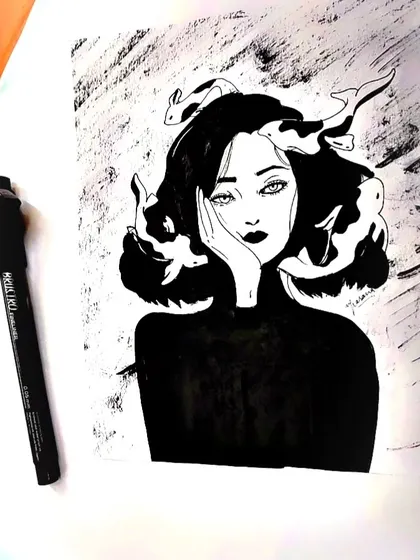 The original artwork of the woman with fish in her hair, shown with the pen I used to create it. This piece is drawn entirely in black ink, using high contrast to create a powerful visual impact.