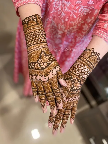 A beautiful, dense mehendi design perfect for a celebration. The patterns are a mix of floral and geometric shapes, creating a rich and textured look.