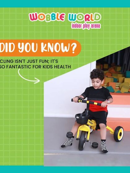 A young boy enjoying a ride on a tricycle. Our toddler area includes a variety of ride-on toys for little ones to practice their coordination.