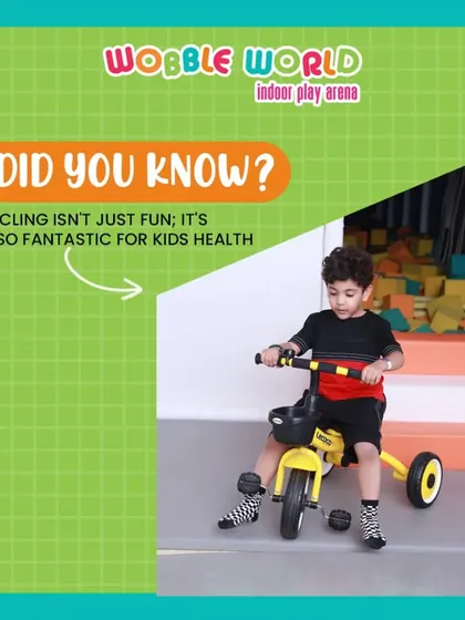 A young boy enjoying a ride on a tricycle. Our toddler area includes a variety of ride-on toys for little ones to practice their coordination.