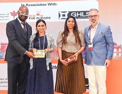 Receiving an award at FUE ASIA 2023. It was also a proud moment as doctors from my team won second place in the quiz, showcasing our clinic's collective expertise.