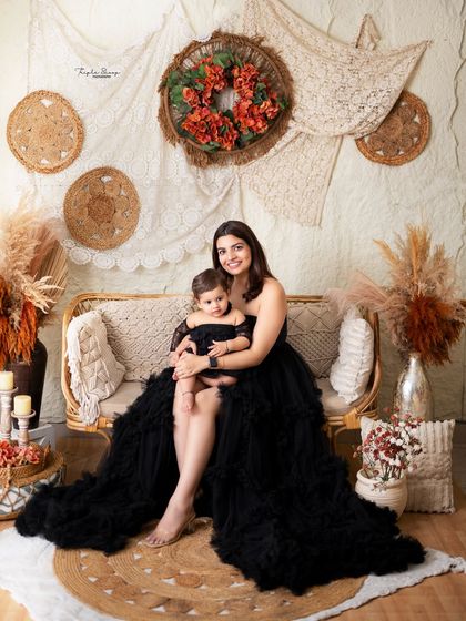 A stunning mother-daughter portrait in matching black outfits. I offer a client closet with beautiful gowns for moms to make your session extra special.
