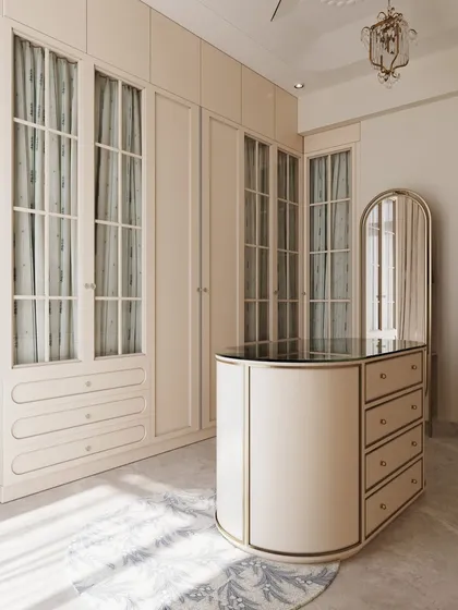 The curved lines of the central island and mirror contrast beautifully with the linear wardrobes, creating a dynamic yet harmonious space.