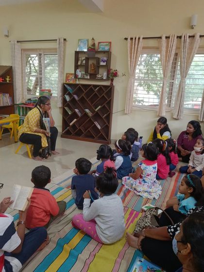 A group of children and parents listen intently to a story about Hairy Hettie. Our sessions are designed for family enjoyment, providing a wonderful opportunity for shared experiences.