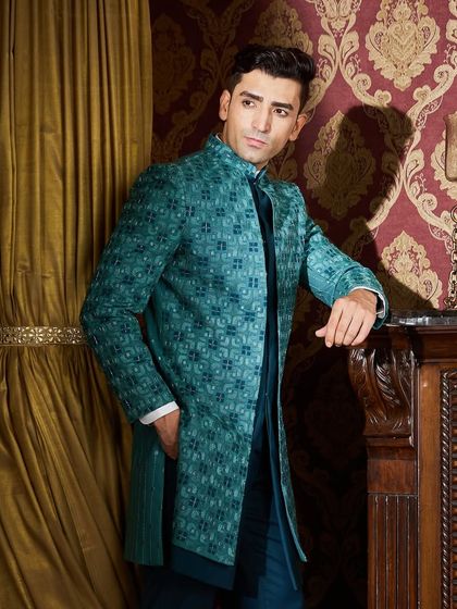 A relaxed yet powerful pose, this image highlights the luxurious feel of the fabric and the way the jacket is structured to command attention.