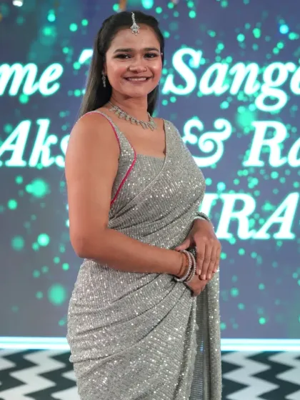 A smiling portrait from the Sangeet night of Akshay and Radhika.