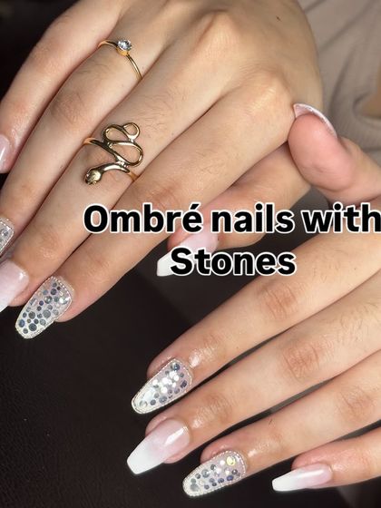 A stunning white ombré on long coffin nails, with accent nails completely covered in shimmering stones.