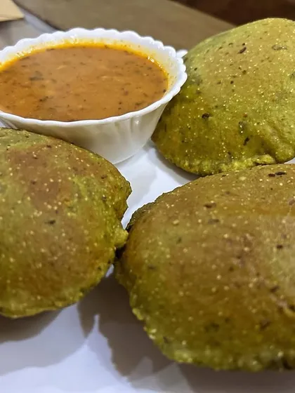 Fluffy Palak Pooris (spinach-infused fried bread) served with Aloo Sabzi. The pooris are not just tasty but also have the goodness of spinach.