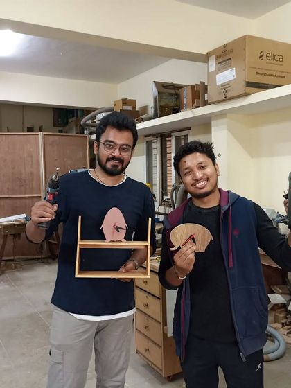 Ram and Gyanesh with their first day's projects. They learned to use a jigsaw to make these fun cutouts and also built a small shelf.