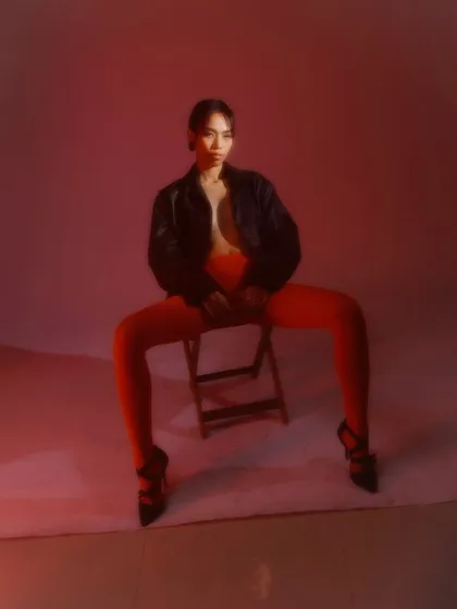 A powerful, wide-stance pose from the 'Lucy in RED' editorial. The minimal makeup ensures the focus remains on the bold styling and the model's strong presence.