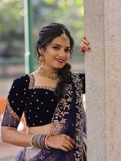 Our beautiful bride-to-be, Vinaya, at her engagement. She chose an elegant antique gold choker that perfectly matches her navy blue lehenga.