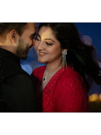 Noor and Dhruv share an intimate moment against the city lights. This portrait captures their closeness and the romantic atmosphere of their evening celebration.